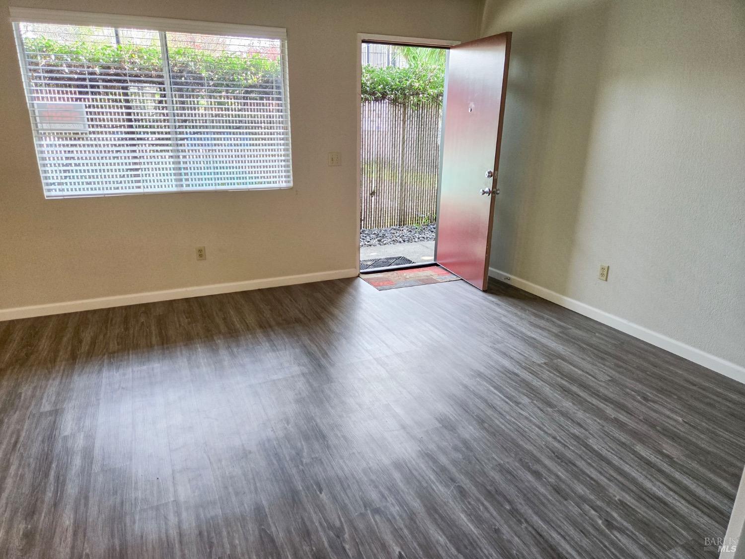 8020 Beverly Drive Rohnert Park, CA 94928 - Photo 29 of 35 an empty room with wooden floor and windows