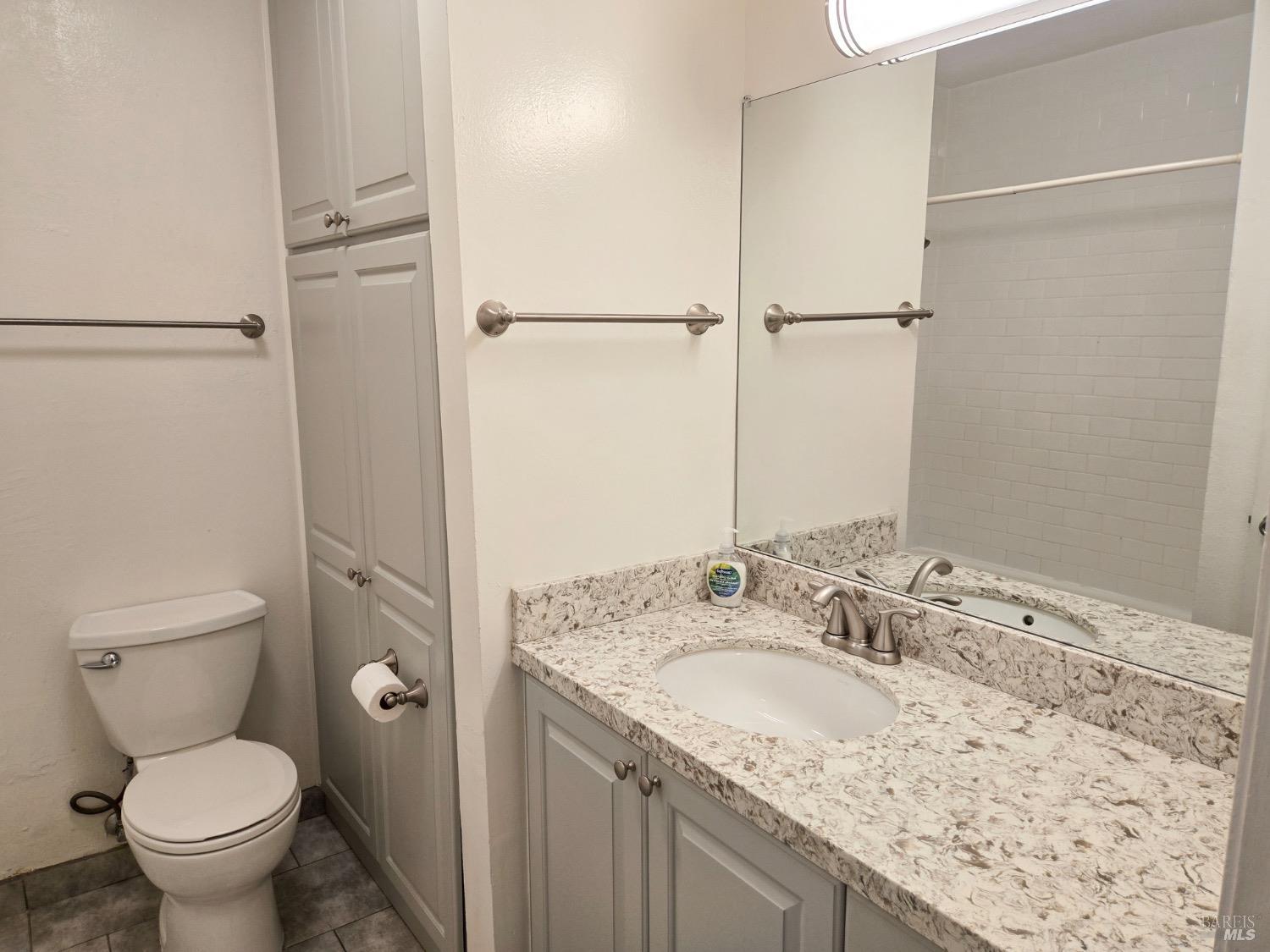8020 Beverly Drive Rohnert Park, CA 94928 - Photo 32 of 35 a bathroom with a granite countertop sink toilet and shower