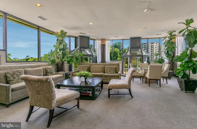 a lobby with furniture and floor to ceiling window
