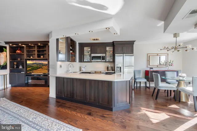 a view of a dining room with furniture and a chandelier