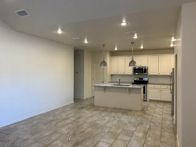a kitchen with stainless steel appliances a sink and cabinets