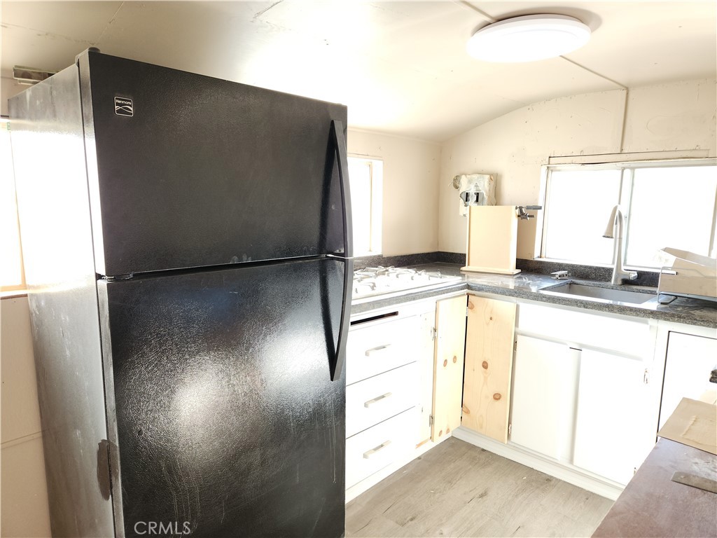 38937 Oleander Newberry Springs, Unit 2 Yermo, CA 92398 - Photo 3 of 10 a bathroom with a refrigerator and a sink