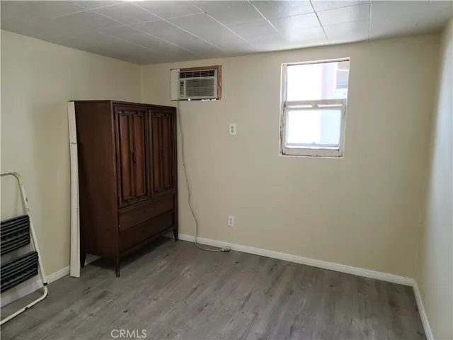 a view of an empty room and wooden floor