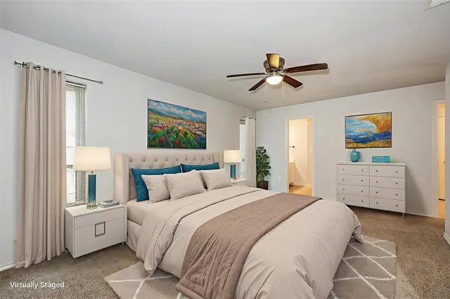 a view of a room with a ceiling fan and hardwood floor