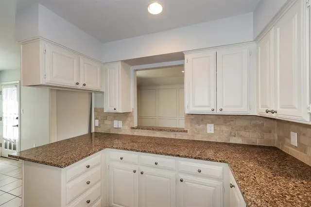 a kitchen with stainless steel appliances a stove a microwave and cabinets