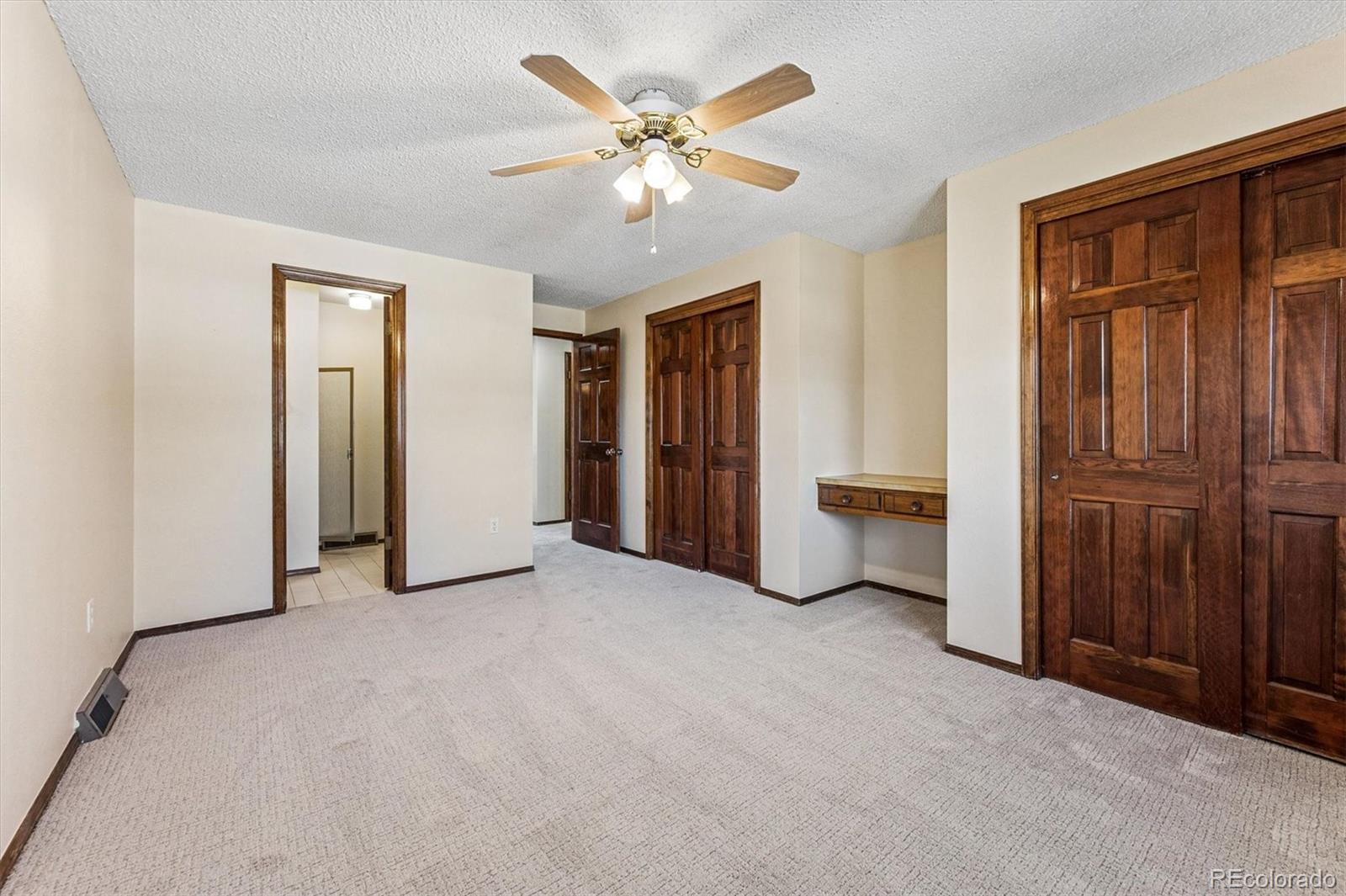 6505 West 34th Avenue Wheat Ridge, CO 80033 - Photo 13 of 28 an empty room with closet and a ceiling fan