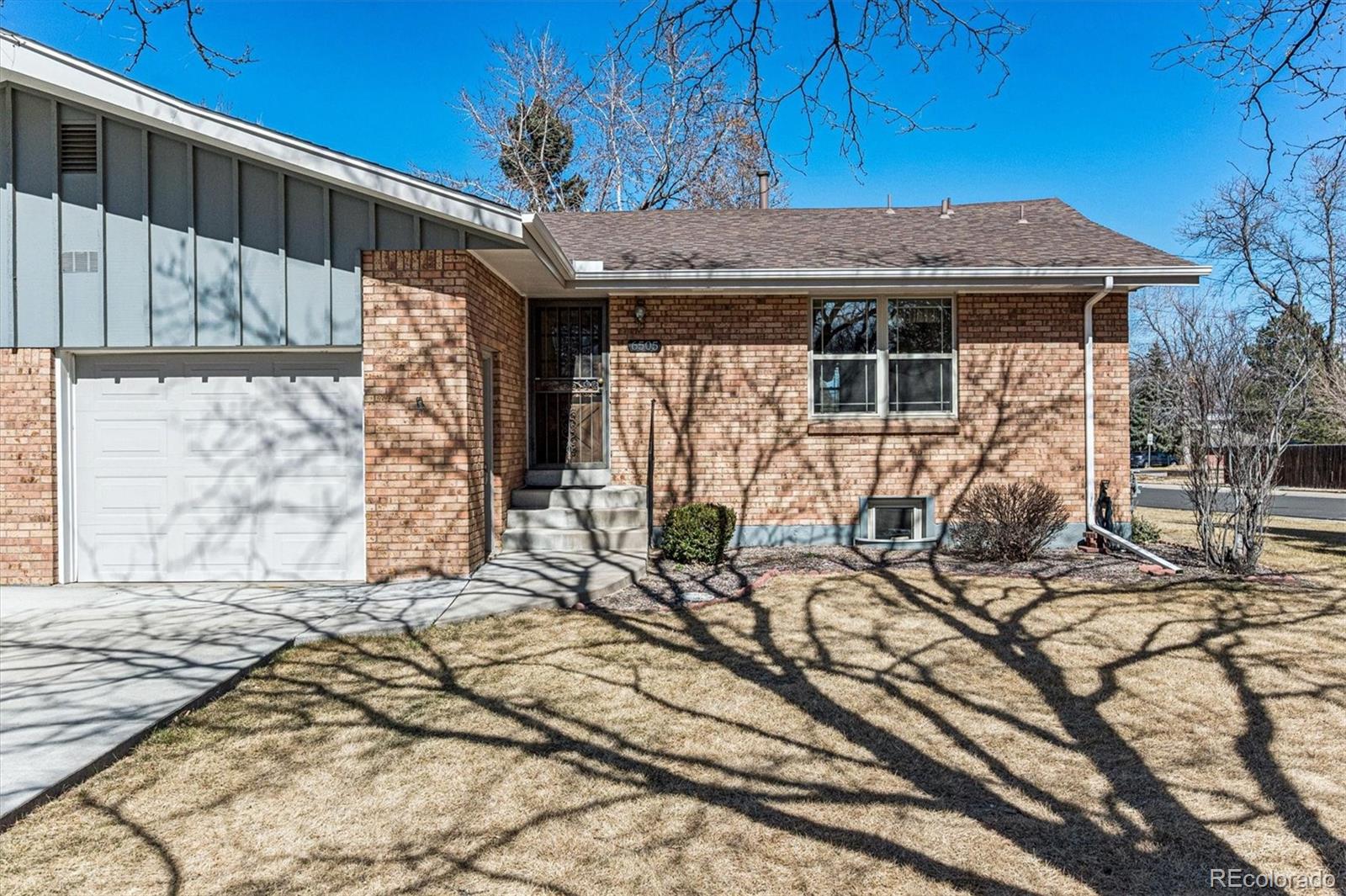 6505 West 34th Avenue Wheat Ridge, CO 80033 - Photo 2 of 28 a front view of a house with a yard