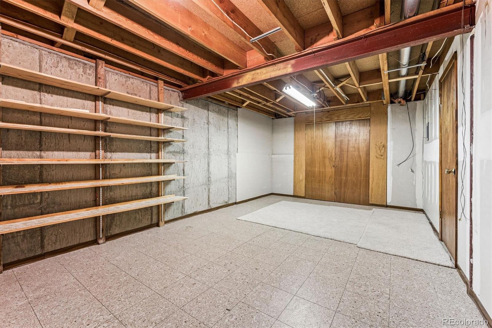6505 West 34th Avenue Wheat Ridge, CO 80033 - Photo 21 of 28 a view of an empty room with a white door