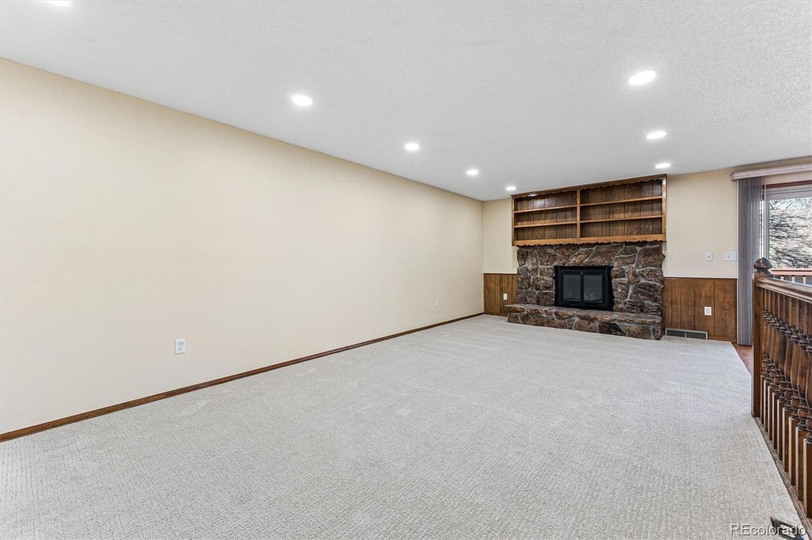 6505 West 34th Avenue Wheat Ridge, CO 80033 - Photo 5 of 28 a view of empty room with a fireplace