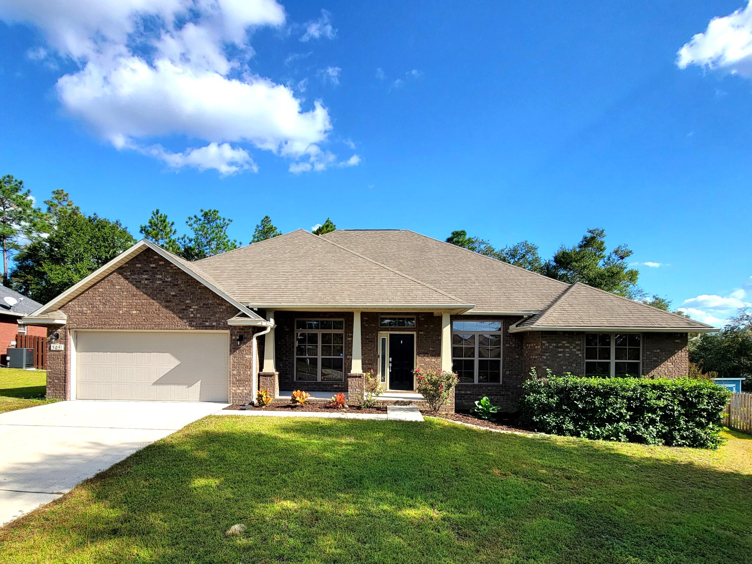 a front view of a house with swimming pool having outdoor seating