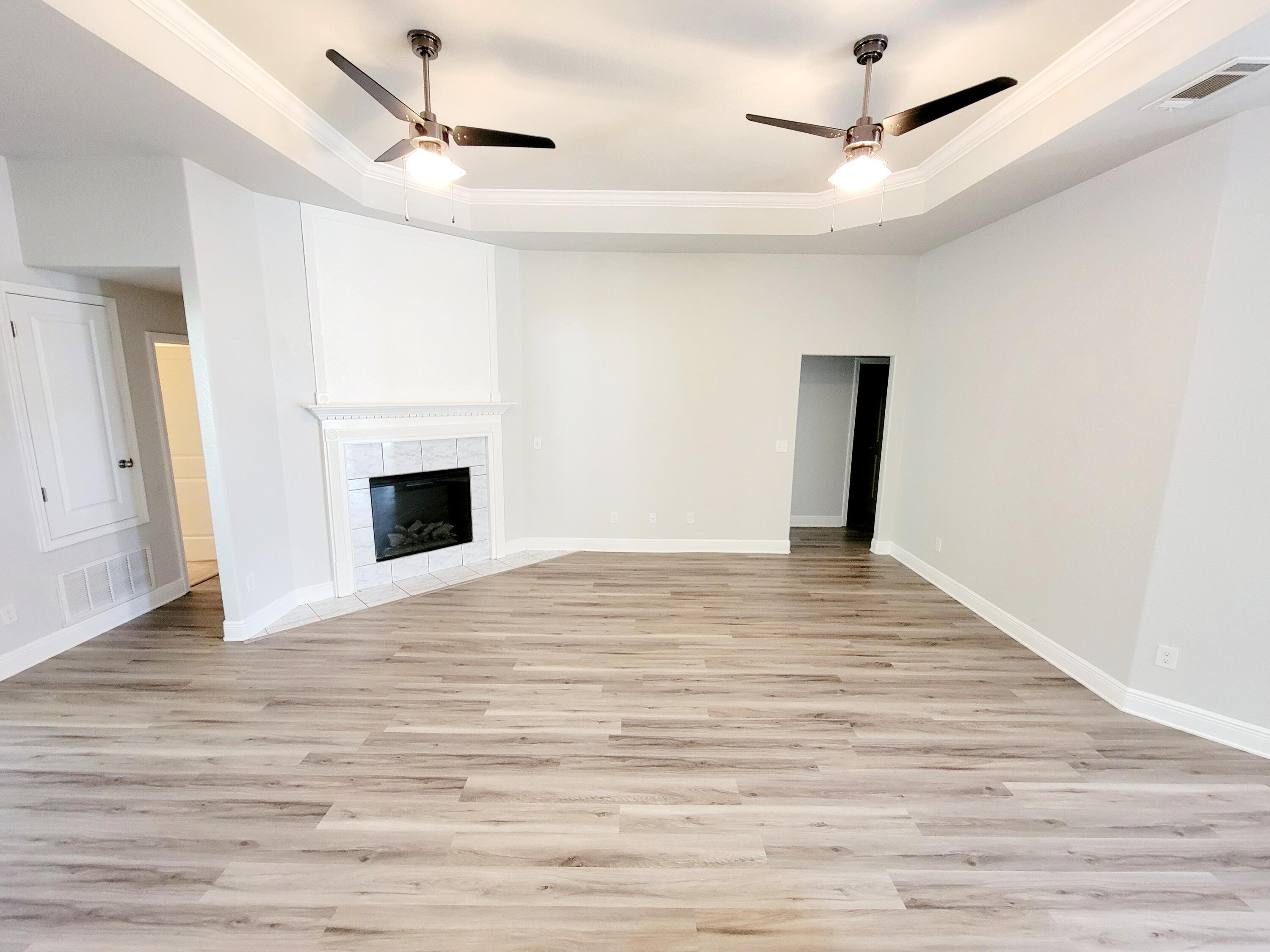 505 Vale Loop Crestview, FL 32536 - Photo 5 of 14 a view of empty room with wooden floor and fireplace