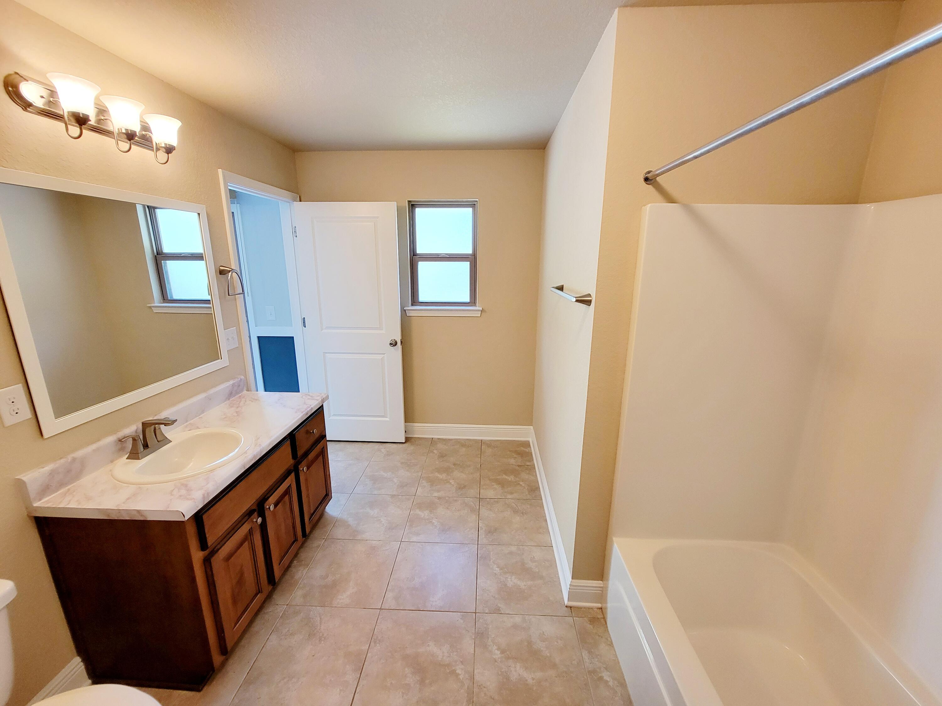 505 Vale Loop Crestview, FL 32536 - Photo 10 of 14 a bathroom with a tub sink and mirror