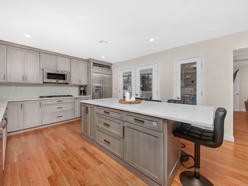 128 Olde Field Road Newton, MA 02459 - Photo 11 of 36 a kitchen with stainless steel appliances granite countertop a stove a sink dishwasher and a microwave oven with wooden floor