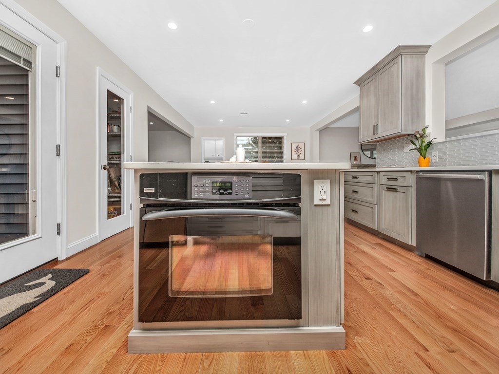 128 Olde Field Road Newton, MA 02459 - Photo 14 of 36 a kitchen with a stove top oven and cabinets