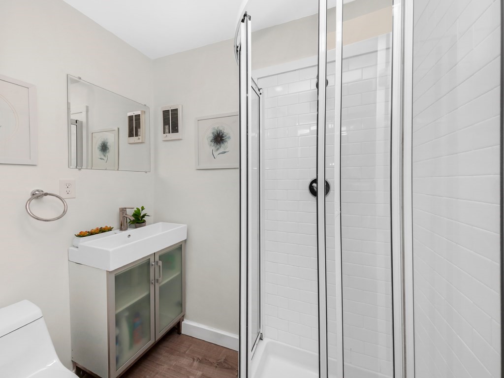 128 Olde Field Road Newton, MA 02459 - Photo 17 of 36 a bathroom with a sink mirror and shower