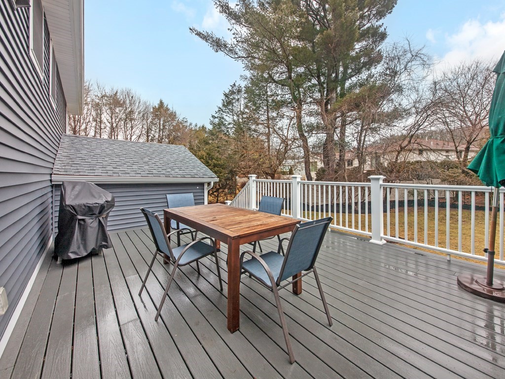 128 Olde Field Road Newton, MA 02459 - Photo 18 of 36 a roof deck with wooden floor and fence