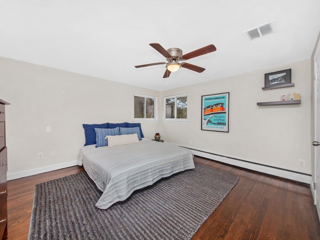 128 Olde Field Road Newton, MA 02459 - Photo 20 of 36 a bedroom with a large bed and a chandelier