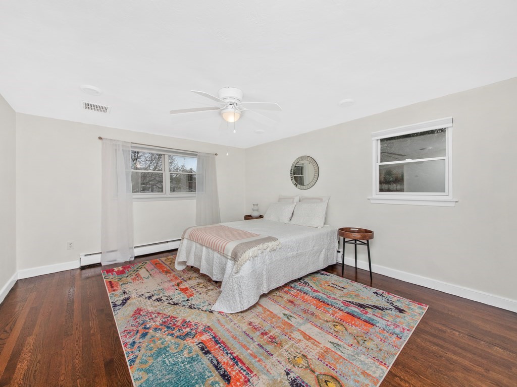 128 Olde Field Road Newton, MA 02459 - Photo 21 of 36 a bedroom with a bed and a wooden floor