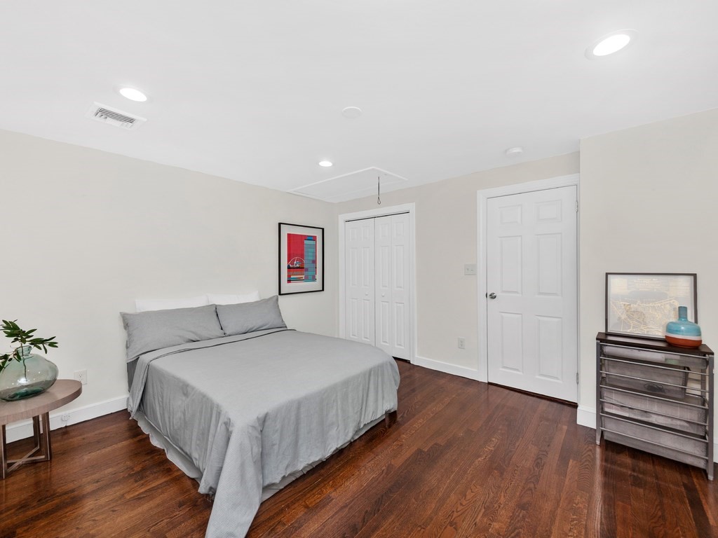 128 Olde Field Road Newton, MA 02459 - Photo 22 of 36 a bedroom with a bed and wooden floor