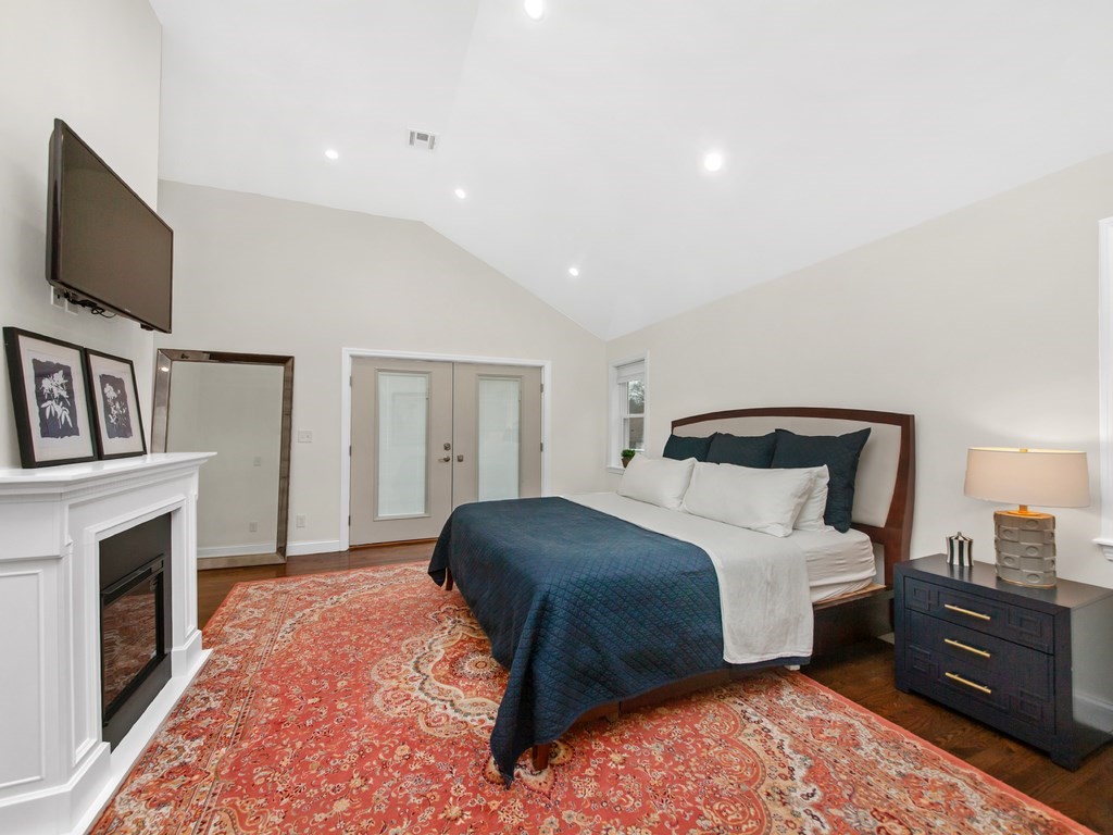 128 Olde Field Road Newton, MA 02459 - Photo 24 of 36 a bedroom with a bed and a flat screen tv
