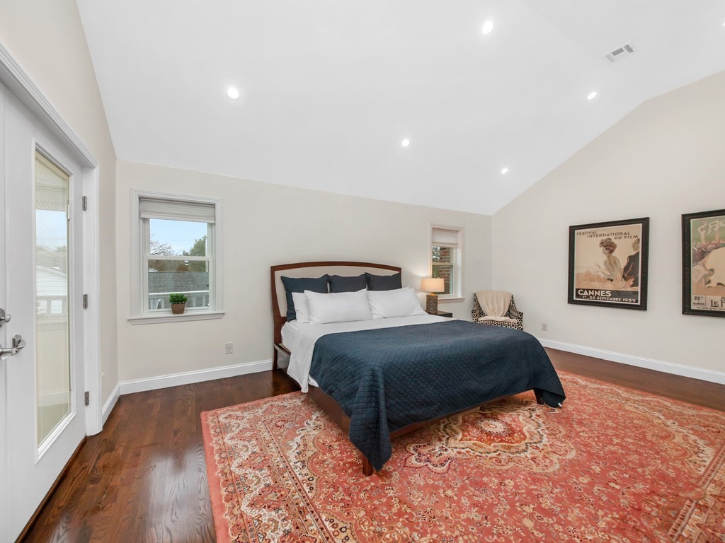 128 Olde Field Road Newton, MA 02459 - Photo 25 of 36 a bedroom with a large bed and a wooden floor
