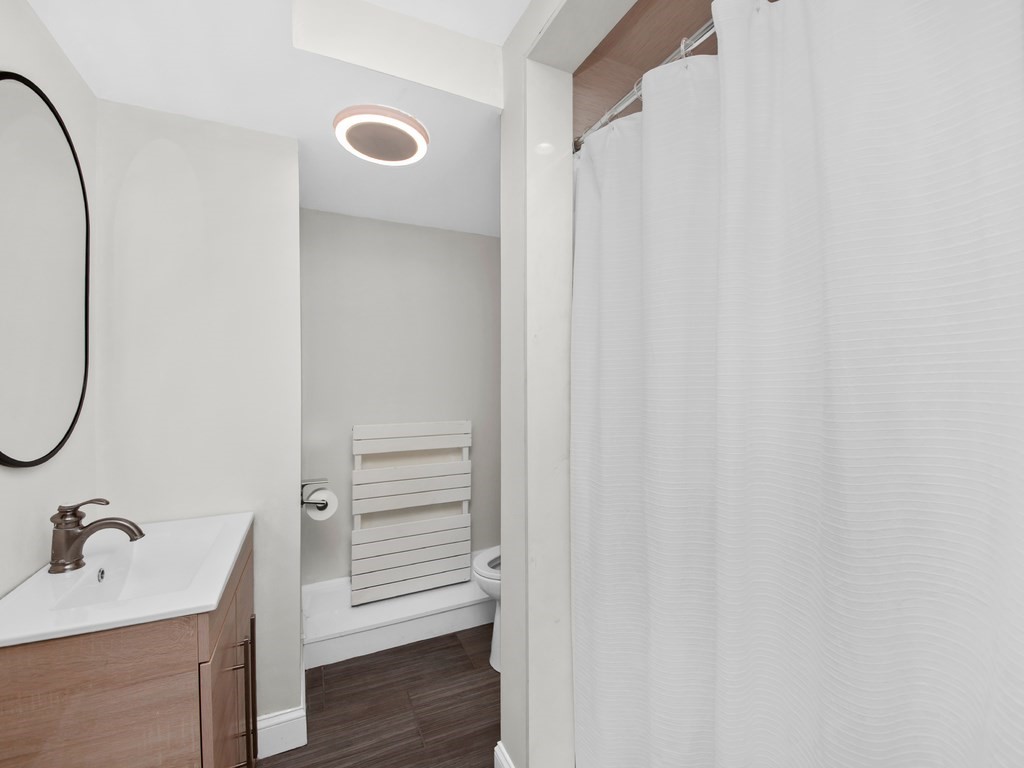 128 Olde Field Road Newton, MA 02459 - Photo 31 of 36 a bathroom with a sink and a mirror