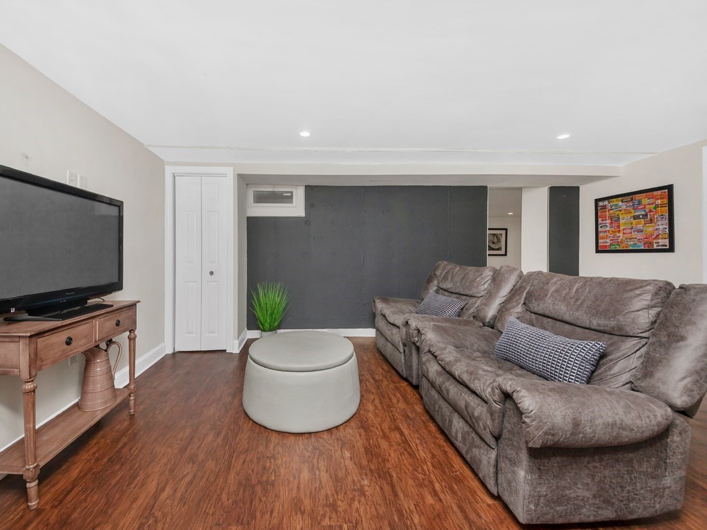 128 Olde Field Road Newton, MA 02459 - Photo 32 of 36 a living room with furniture and a flat screen tv