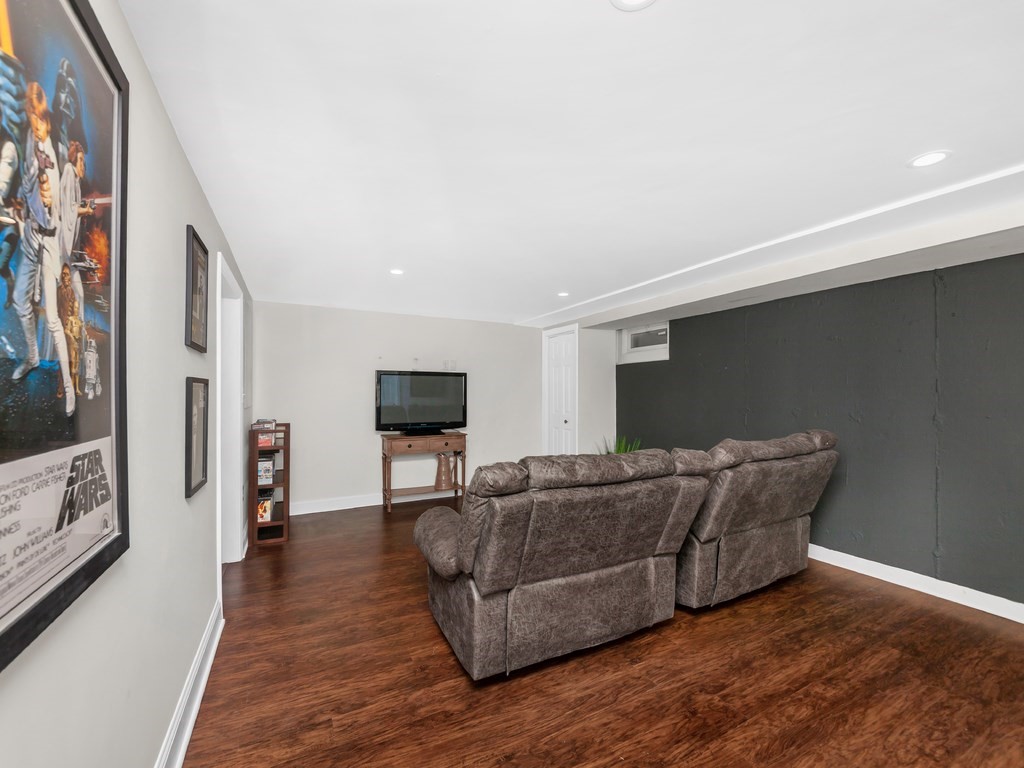128 Olde Field Road Newton, MA 02459 - Photo 33 of 36 a living room with furniture and a flat screen tv
