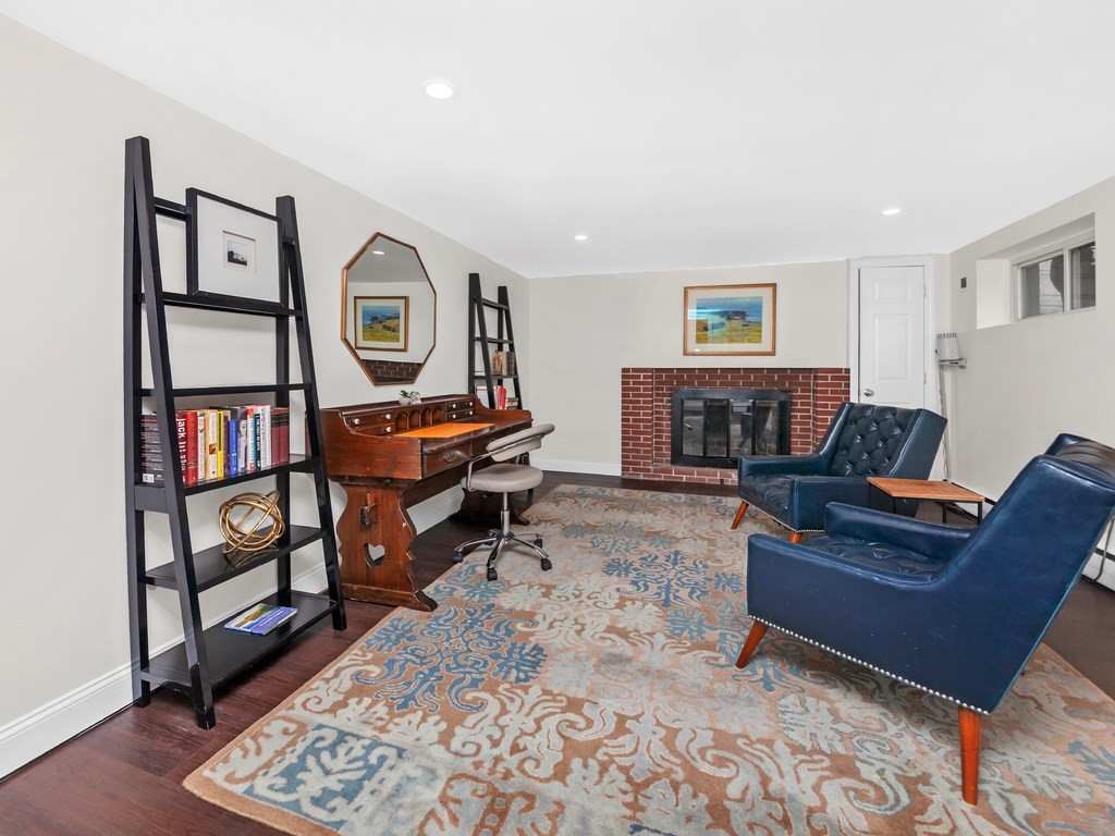 128 Olde Field Road Newton, MA 02459 - Photo 34 of 36 a living room with furniture and a fireplace