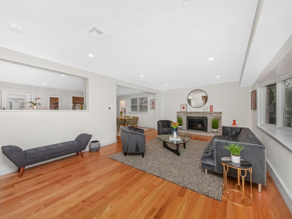 128 Olde Field Road Newton, MA 02459 - Photo 5 of 36 a living room with furniture a rug and a fireplace