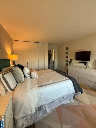 a bedroom with a bed and tv