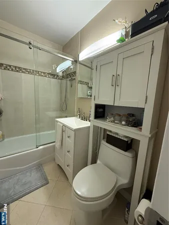 a bathroom with a toilet sink and shower