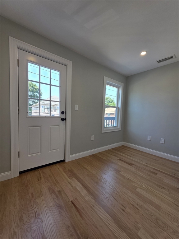 40 Lorna Road, Unit 2 Boston, MA 02126 - Photo 14 of 18 an empty room with wooden floor and windows
