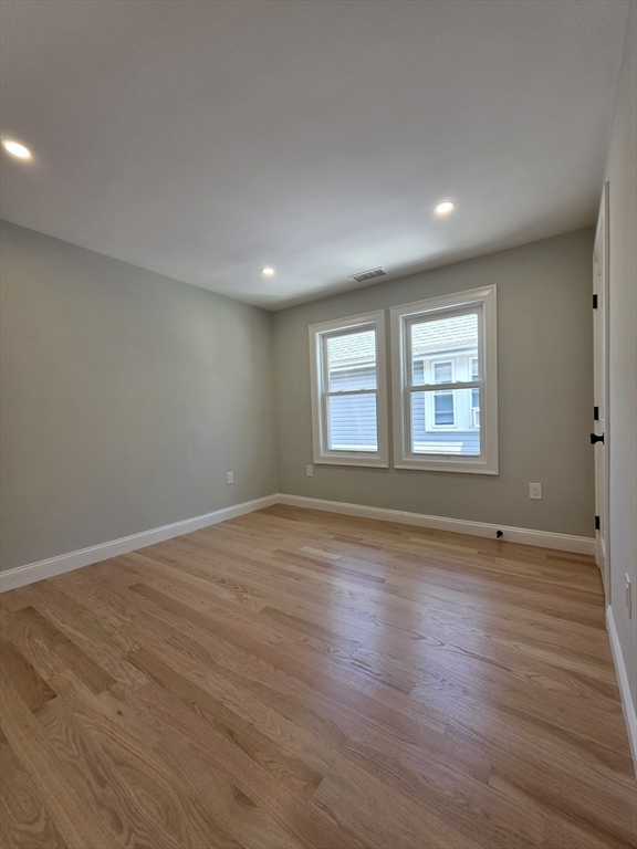40 Lorna Road, Unit 2 Boston, MA 02126 - Photo 16 of 18 a view of an empty room with wooden floor and window