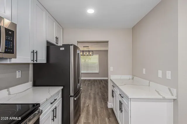 a kitchen with a sink and a refrigerator