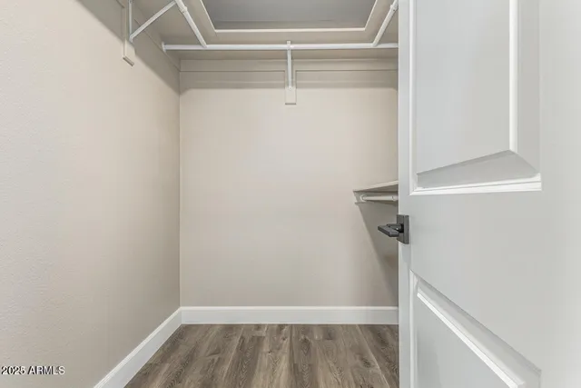 a view of walk in closet with clothes