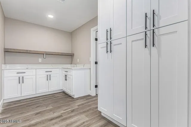 a view of a kitchen with white cabinets