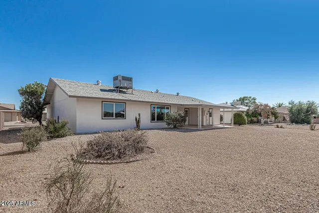 a view of a house with a backyard