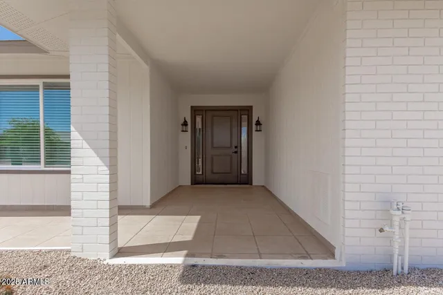 a view of a hallway with wooden floor and entryway