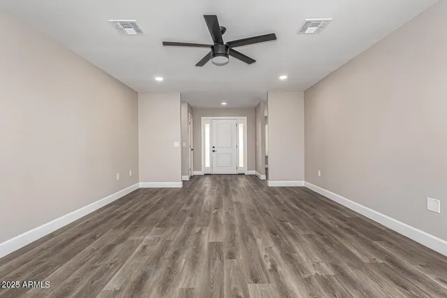 a view of an empty room and wooden floor