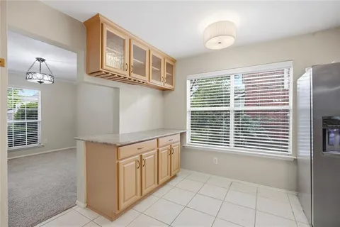 a kitchen with stainless steel appliances granite countertop a stove a sink dishwasher and cabinets with wooden floor