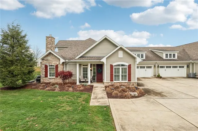 a front view of a house with a garden and patio