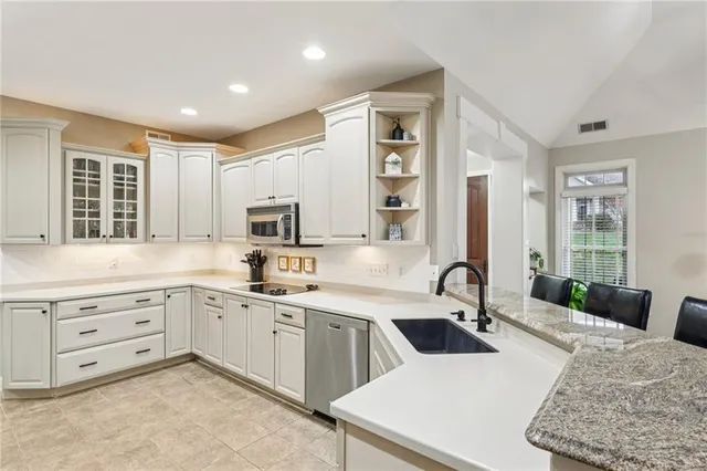 a kitchen with a sink stove and cabinets