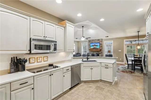 a kitchen with stainless steel appliances granite countertop a sink and cabinets