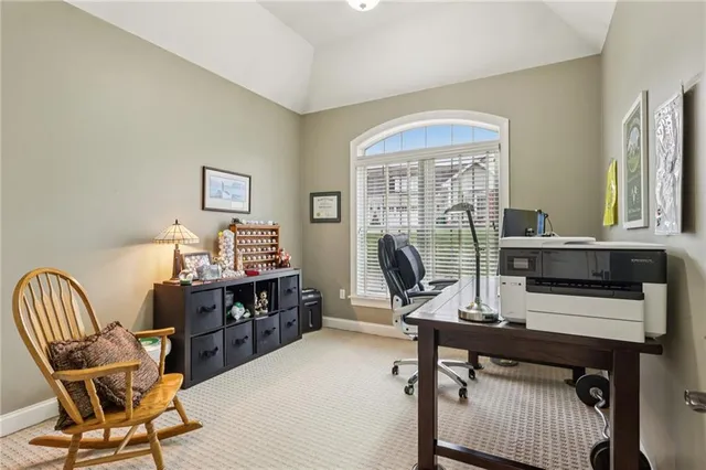 a view of a workspace with furniture and a window