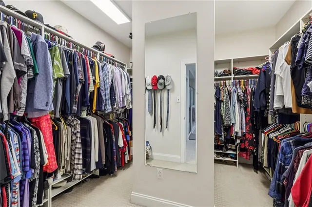 a view of walk in closet with clothes
