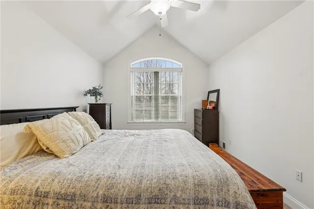 a bedroom with a large bed and a large window