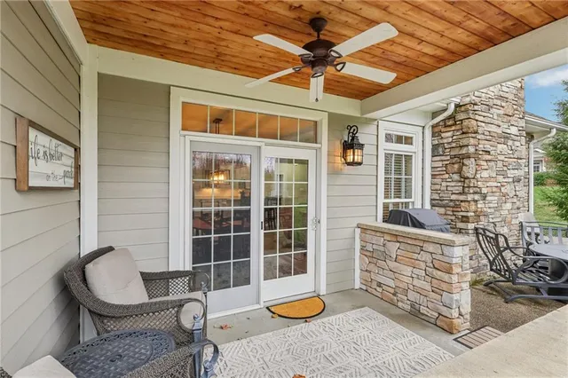 a balcony with furniture and a potted plant