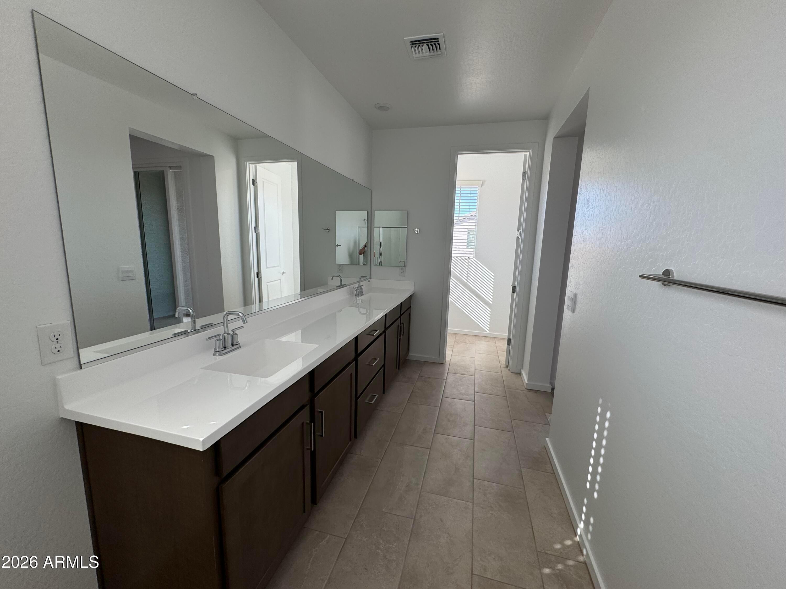 2438 West Rowel Road Phoenix, AZ 85085 - Photo 19 of 30 a bathroom with a double vanity sink and mirror