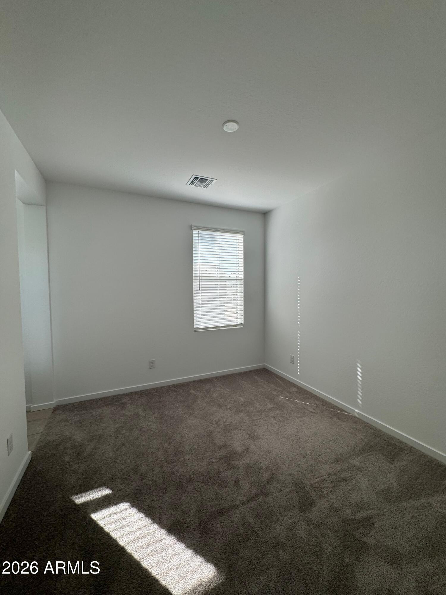 2438 West Rowel Road Phoenix, AZ 85085 - Photo 24 of 30 an empty room with a window